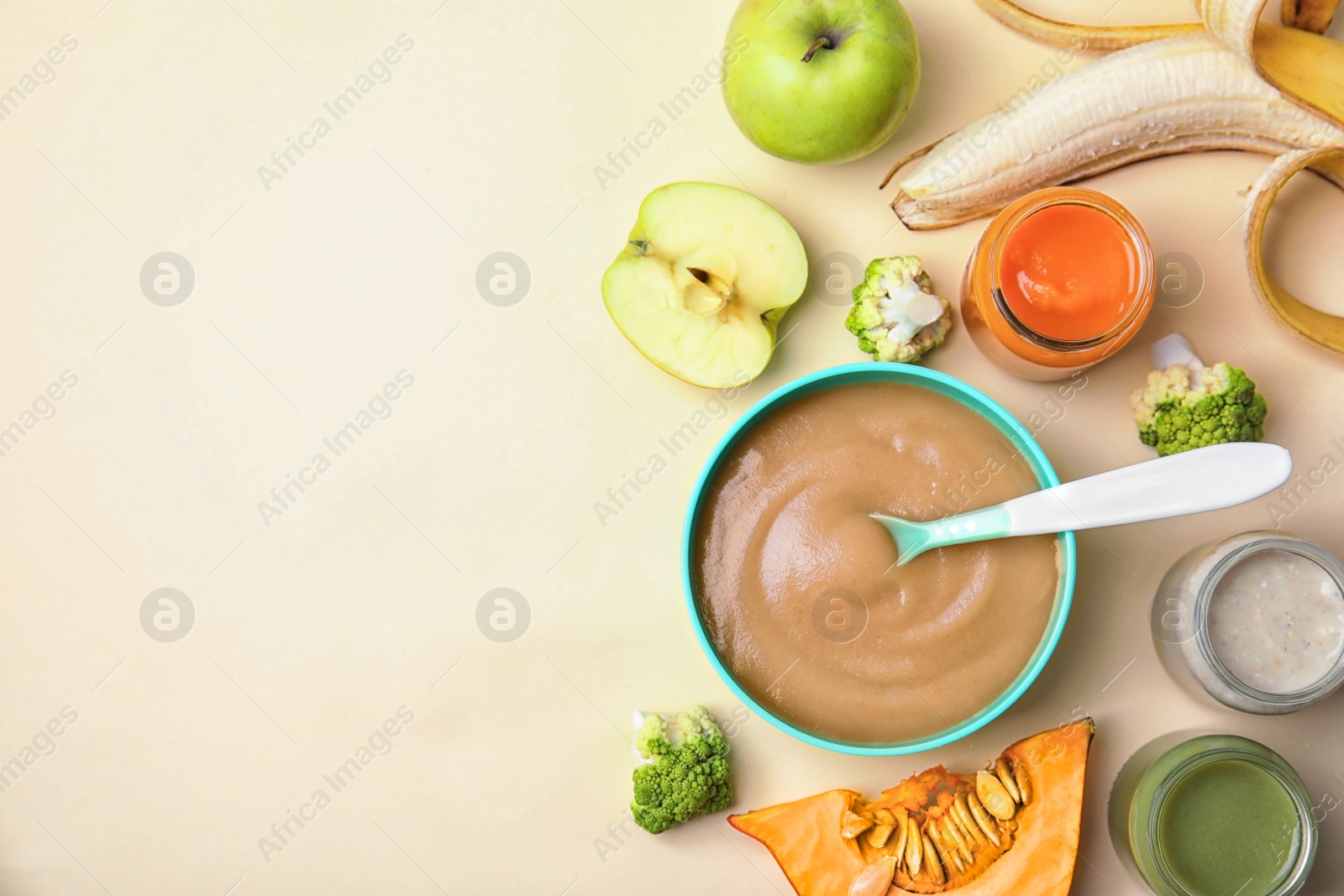 Photo of Flat lay composition with bowl of healthy baby food and space for text on color background