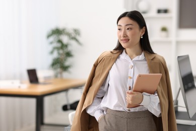 Photo of Portrait of beautiful businesswoman with tablet in office. Space for text