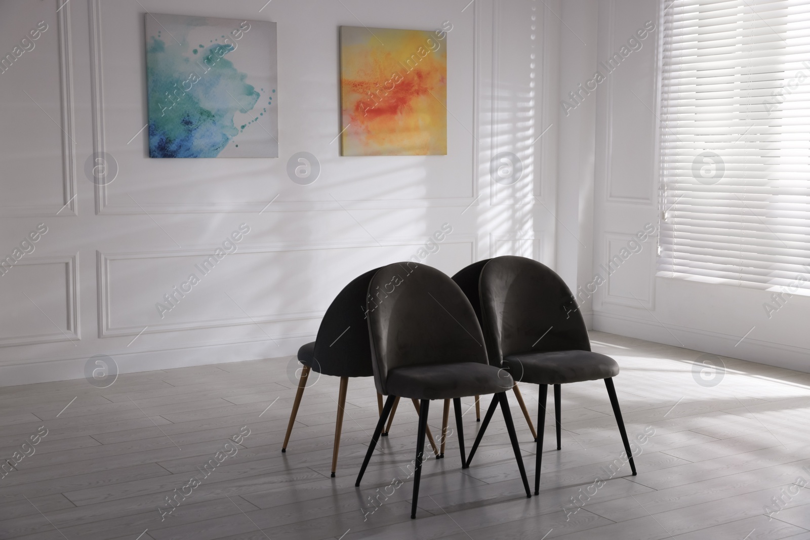 Photo of Chairs and beautiful paintings in art gallery