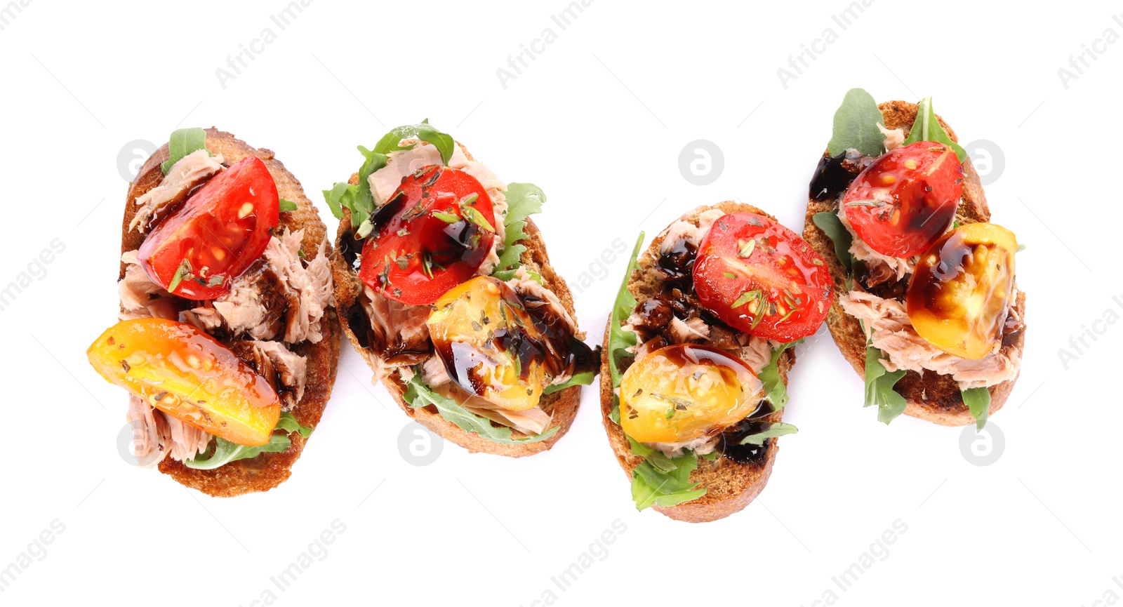 Photo of Delicious bruschettas with balsamic vinegar, tomatoes, arugula and tuna isolated on white, top view