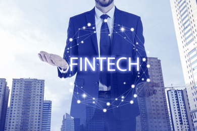 Image of Fintech concept. Double exposure of cityscape and businessman, closeup