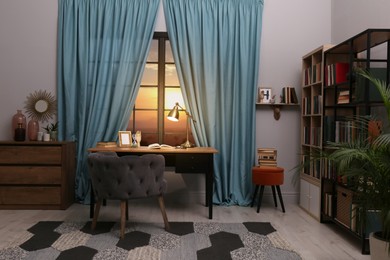 Photo of Cozy home library interior with collection of different books on shelves