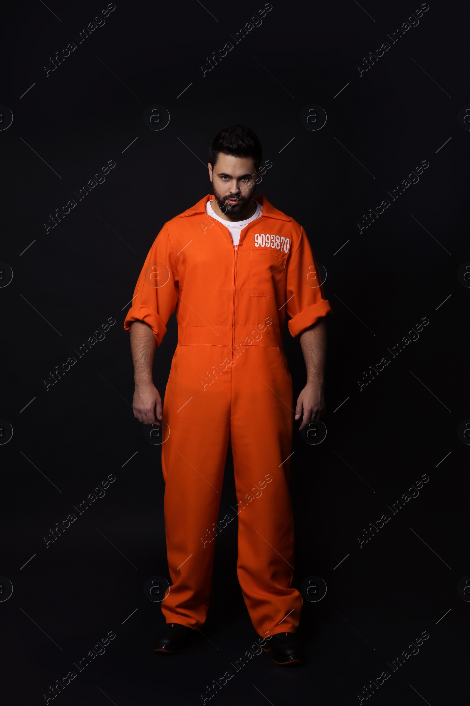 Photo of Prisoner in special jumpsuit on black background