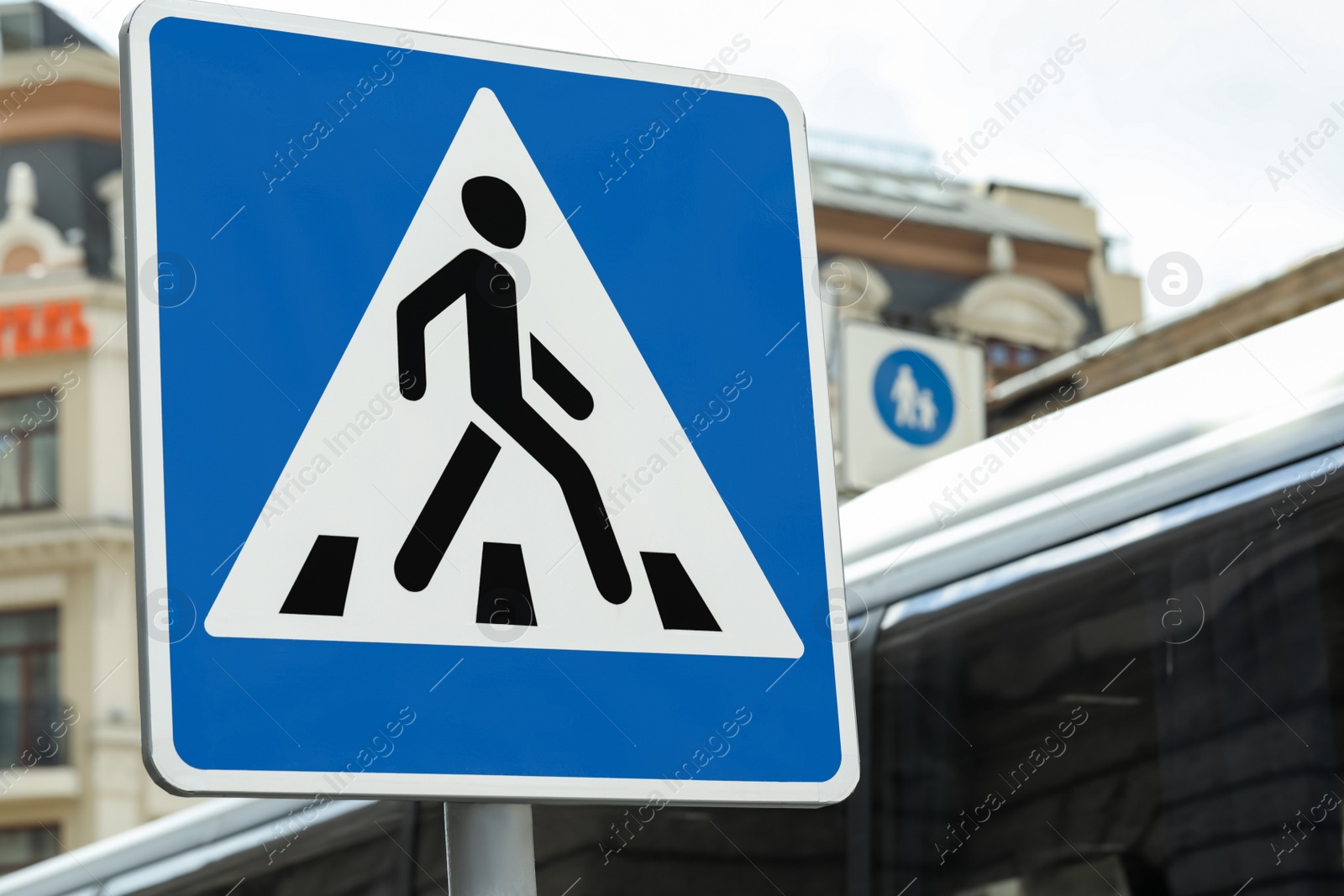 Photo of Post with Pedestrian Crossing road sign in city