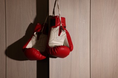 Photo of Red boxing gloves hanging on locker door in changing room
