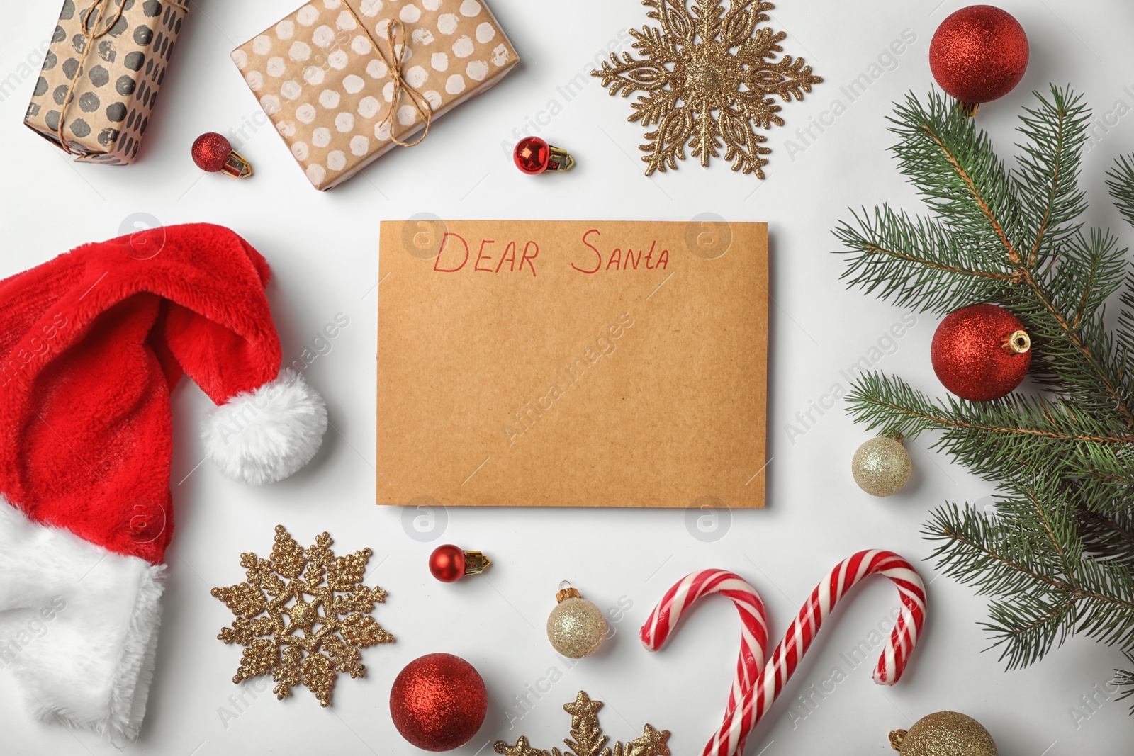 Photo of Flat lay composition with childish letter to Santa Claus and Christmas decoration on white background