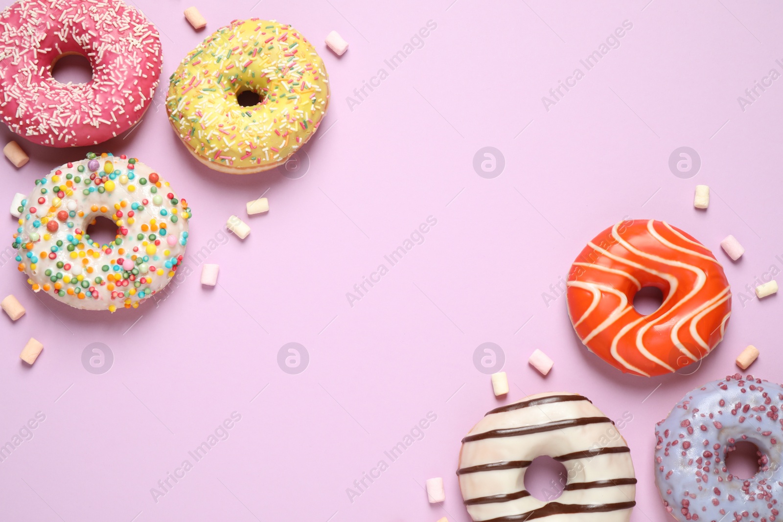 Photo of Delicious glazed donuts on lilac background, flat lay. Space for text
