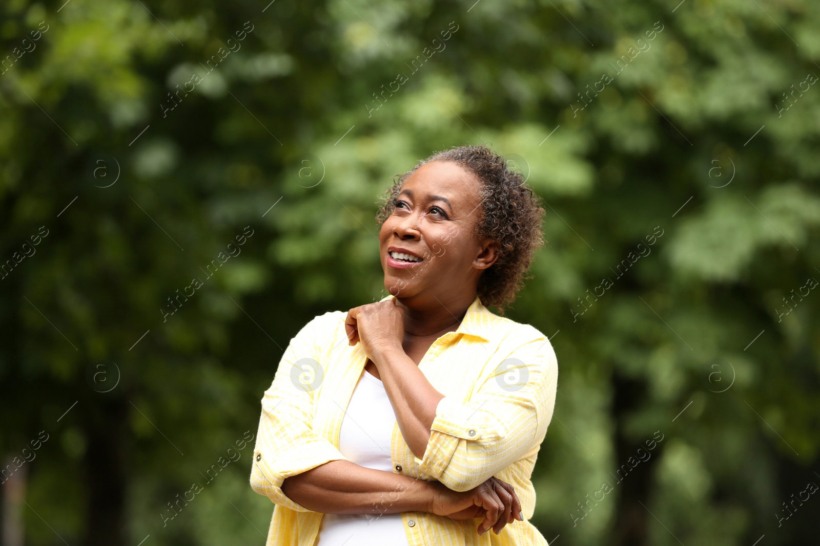 Photo of Portrait of happy African-American woman in park