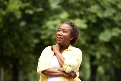 Portrait of happy African-American woman in park