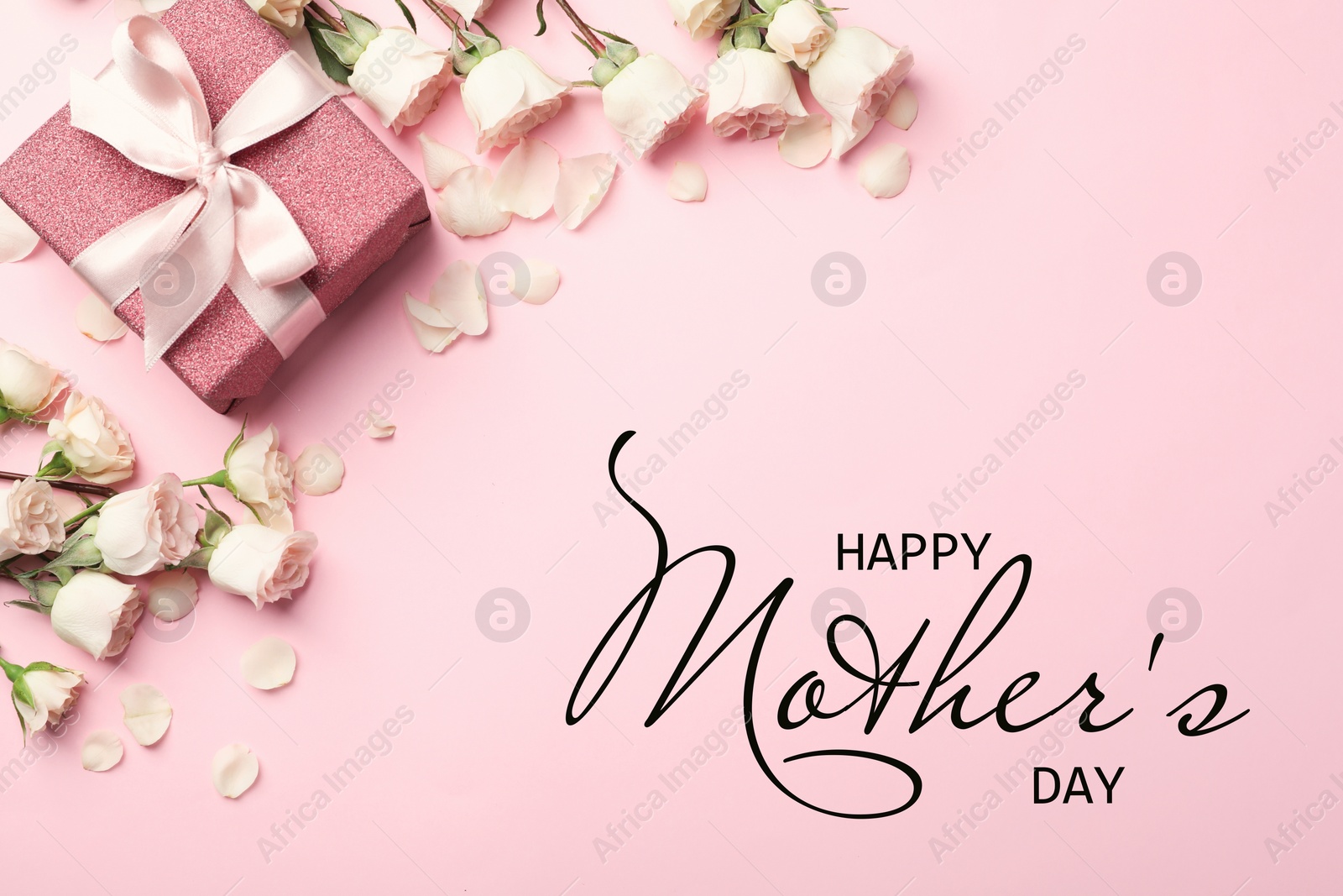 Image of Happy Mother's Day. Greeting card with gift box and beautiful roses on pink background, flat lay