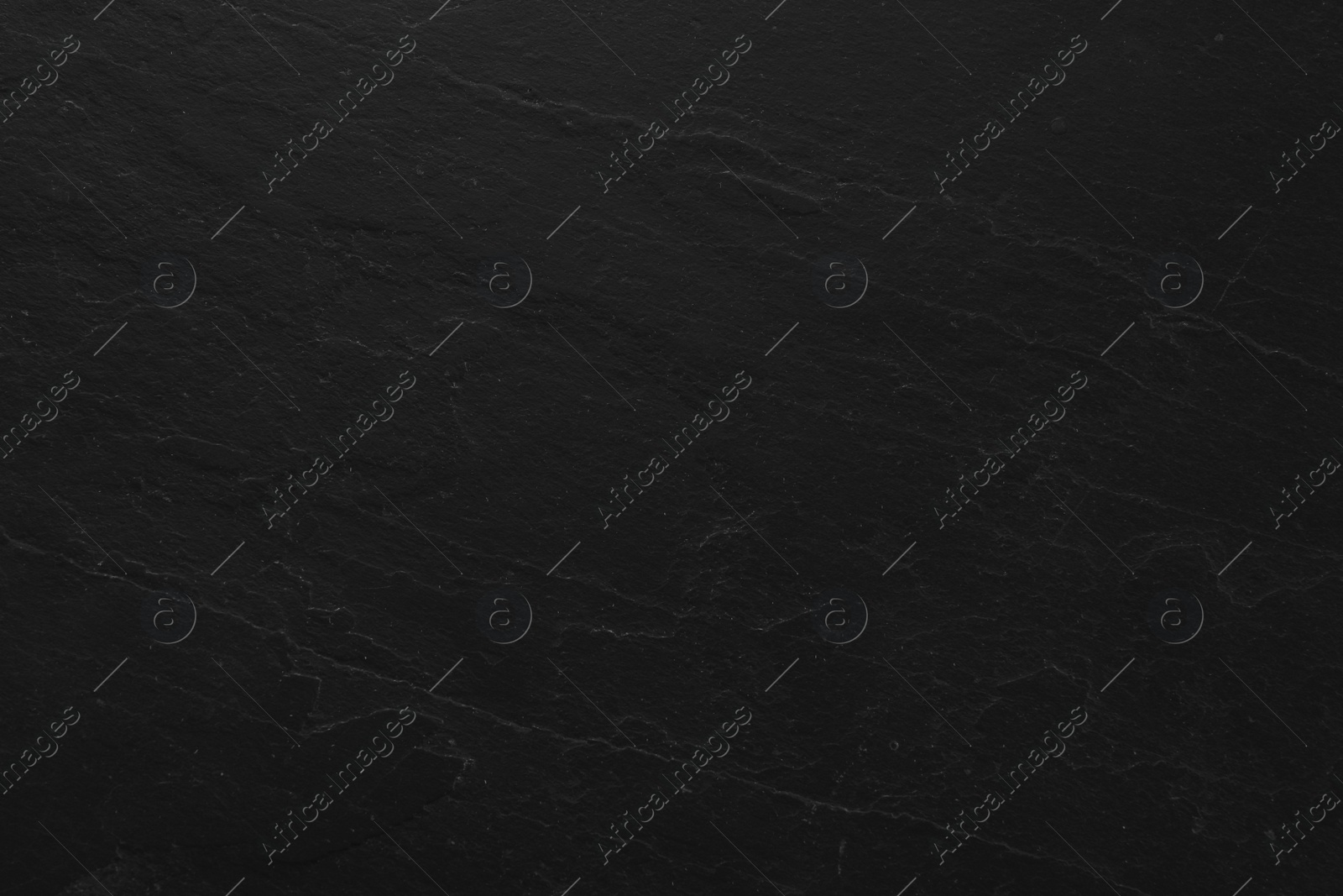 Photo of Texture of black stone surface as background, closeup