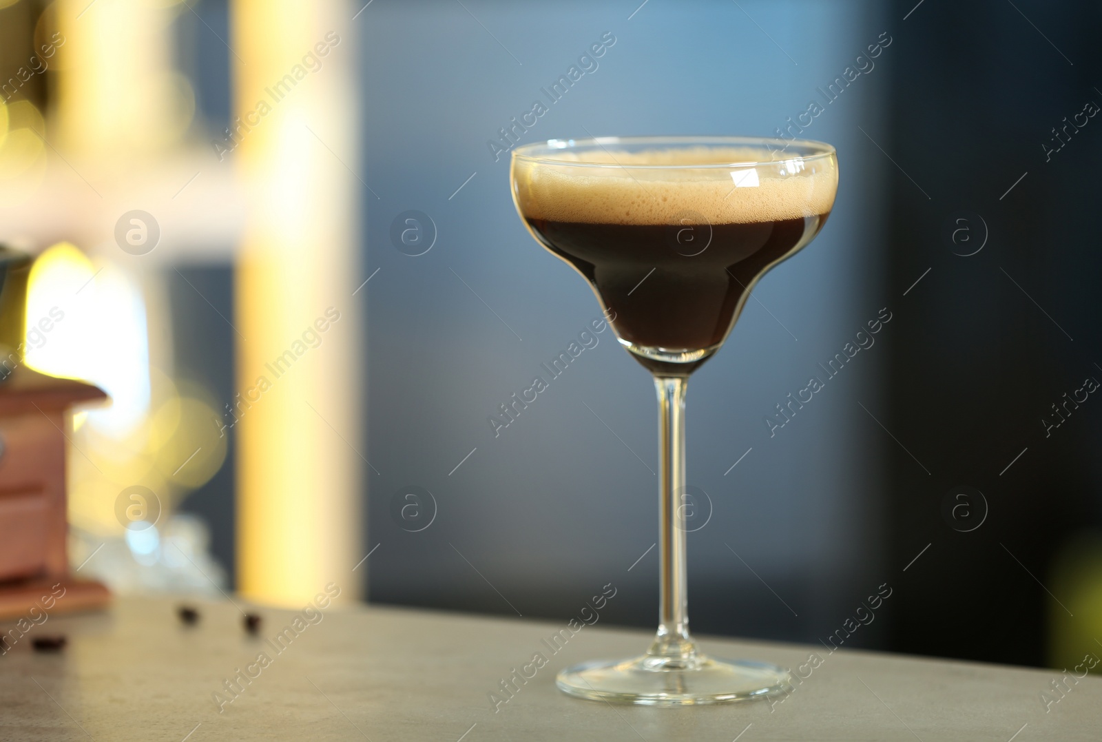 Photo of Fresh alcoholic Martini Espresso cocktail on bar counter, space for text
