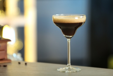 Fresh alcoholic Martini Espresso cocktail on bar counter, space for text