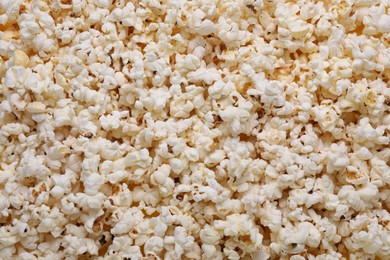 Tasty pop corn as background, top view