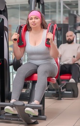 Photo of Overweight woman training in gym