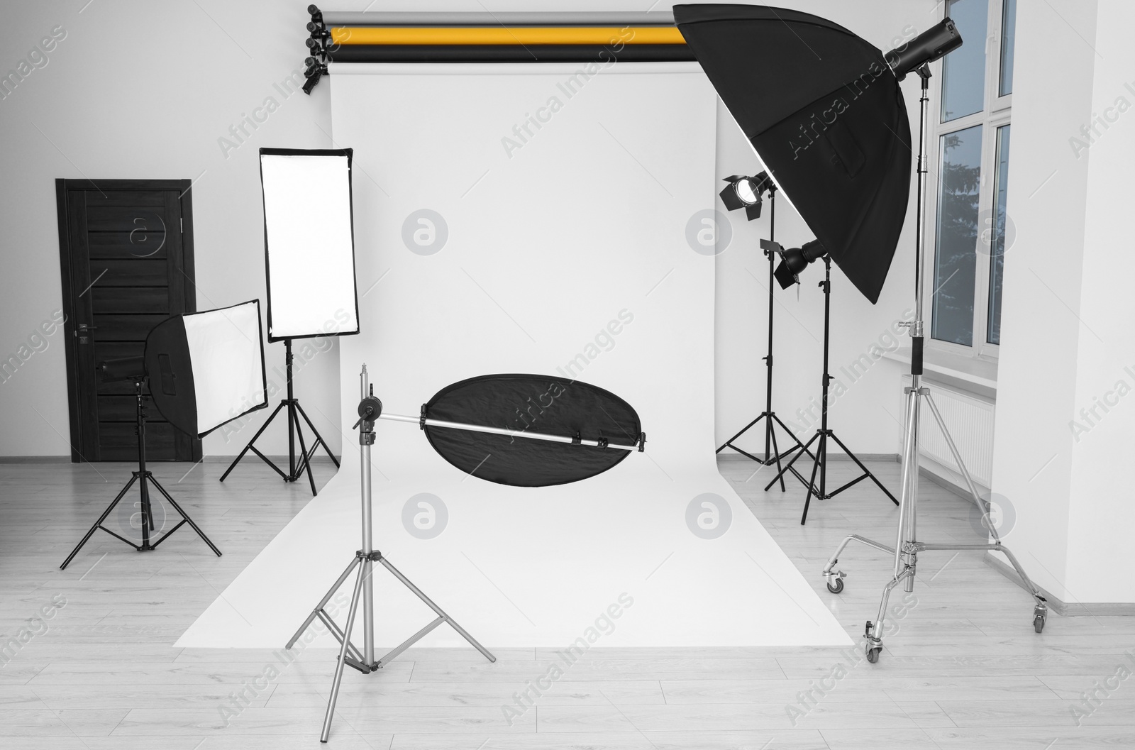 Photo of Interior of modern photo studio with professional lighting equipment