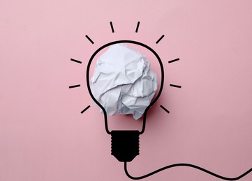 Image of Idea. Illustration of light bulb around crumpled paper ball on pink background, top view