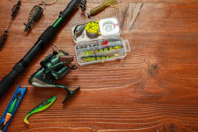 Photo of Fishing tackle on wooden table, above view. Space for text