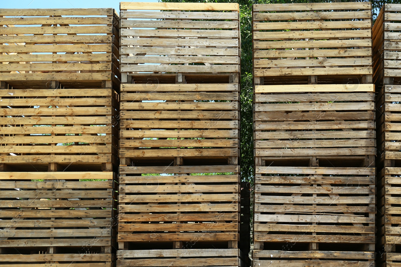Photo of Pile of empty wooden crates outdoors on sunny day