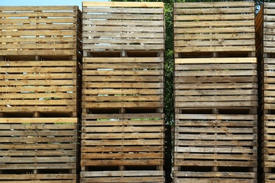 Photo of Pile of empty wooden crates outdoors on sunny day