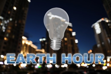 Image of Take care of environment. Light bulb and words Earth Hour against blurred view of night cityscape