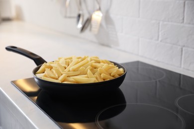 Photo of Frying pan with cut raw potatoes on cooktop, space for text