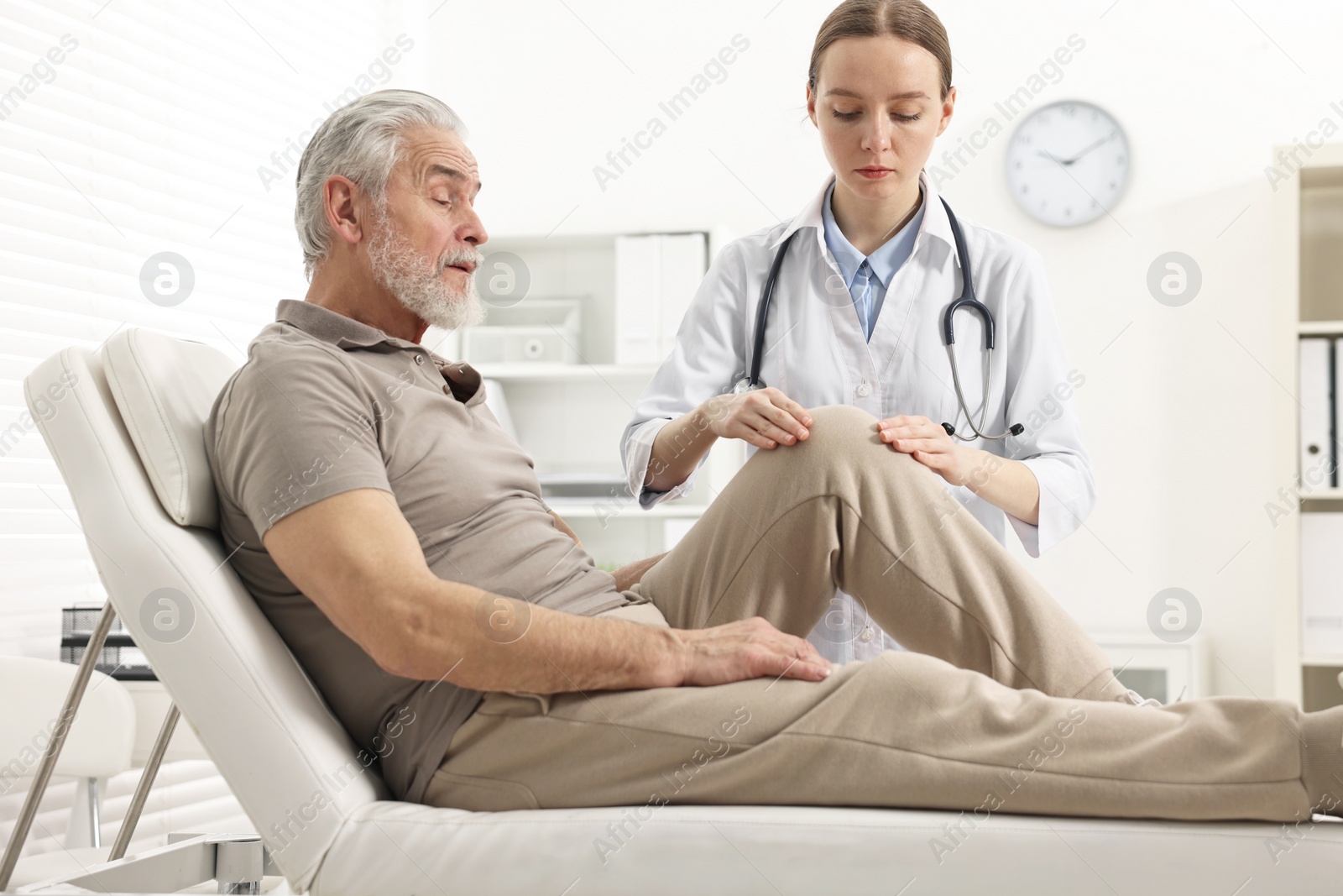 Photo of Arthritis symptoms. Doctor examining patient with knee pain in hospital