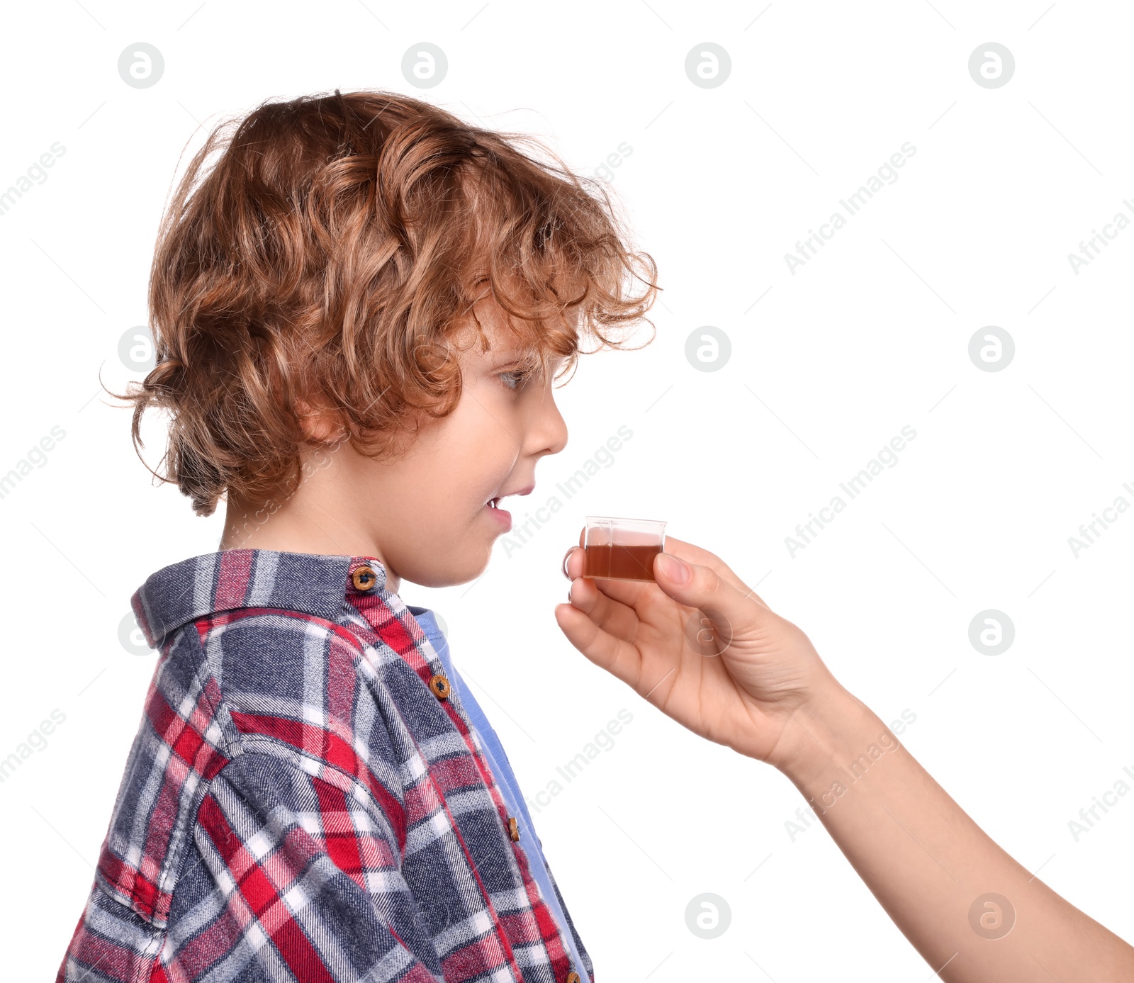 Photo of Mother giving cough syrup to her son against white background, closeup