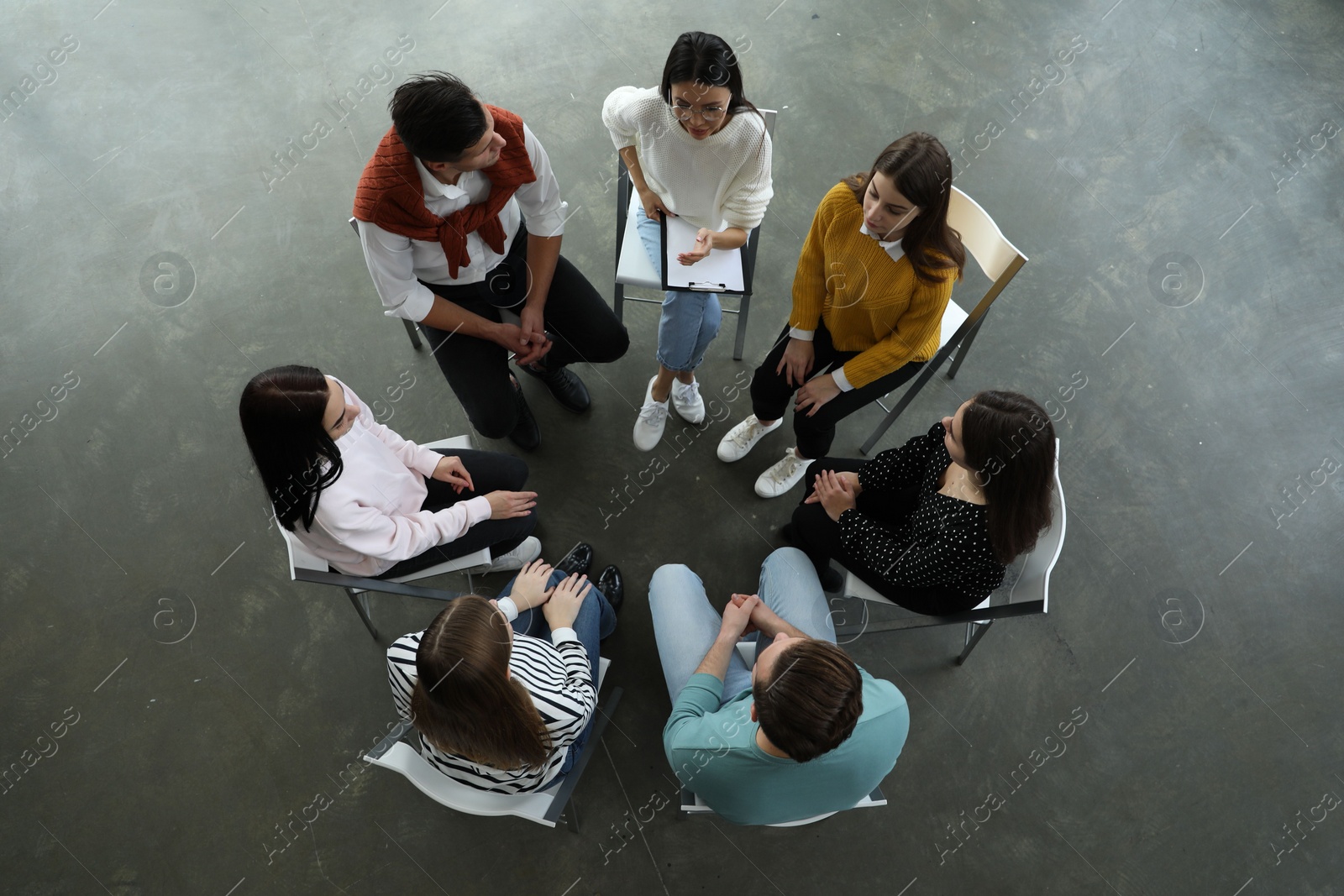 Photo of Psychotherapist working with patients in group therapy session, top view