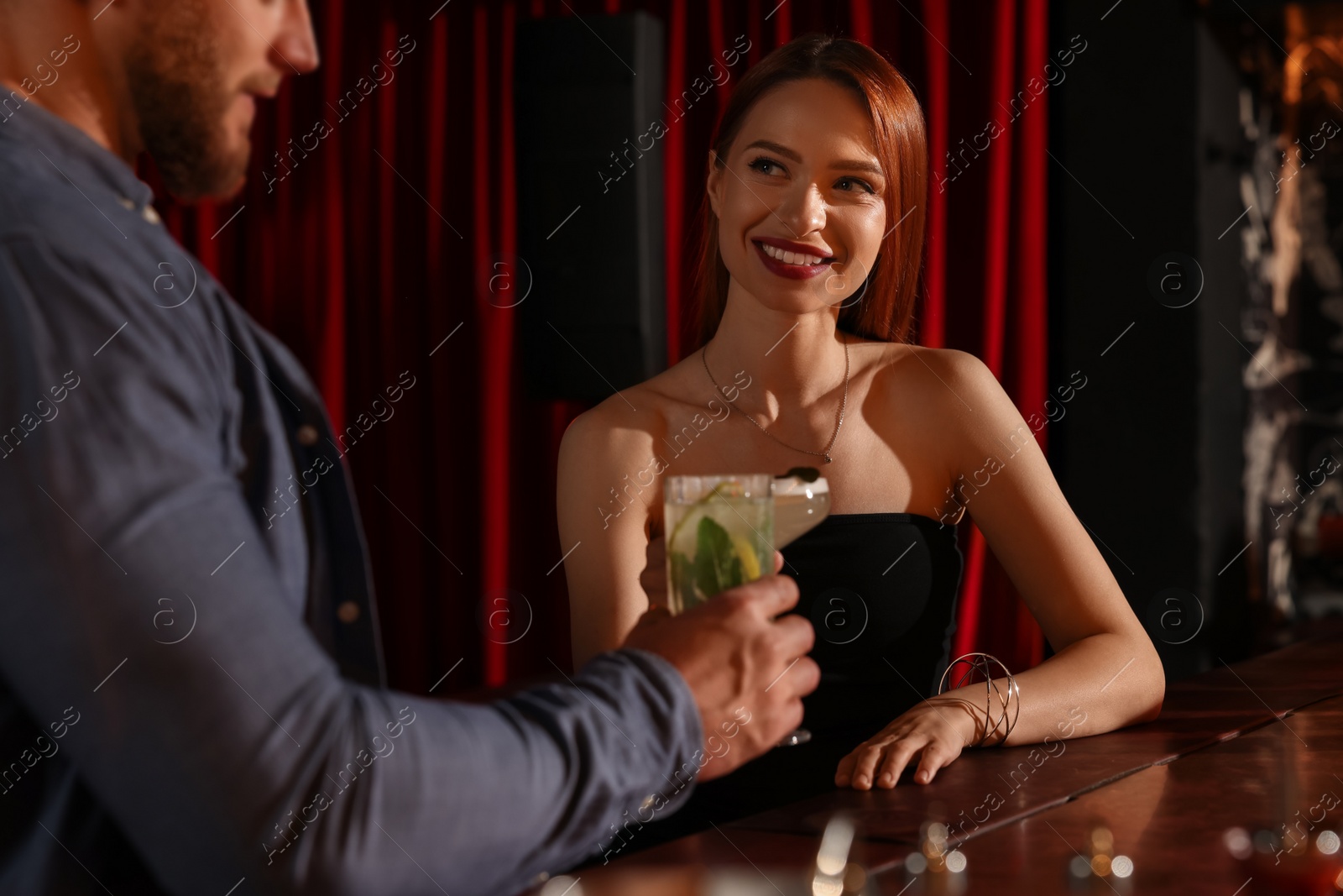 Photo of Couple with fresh cocktails at bar counter