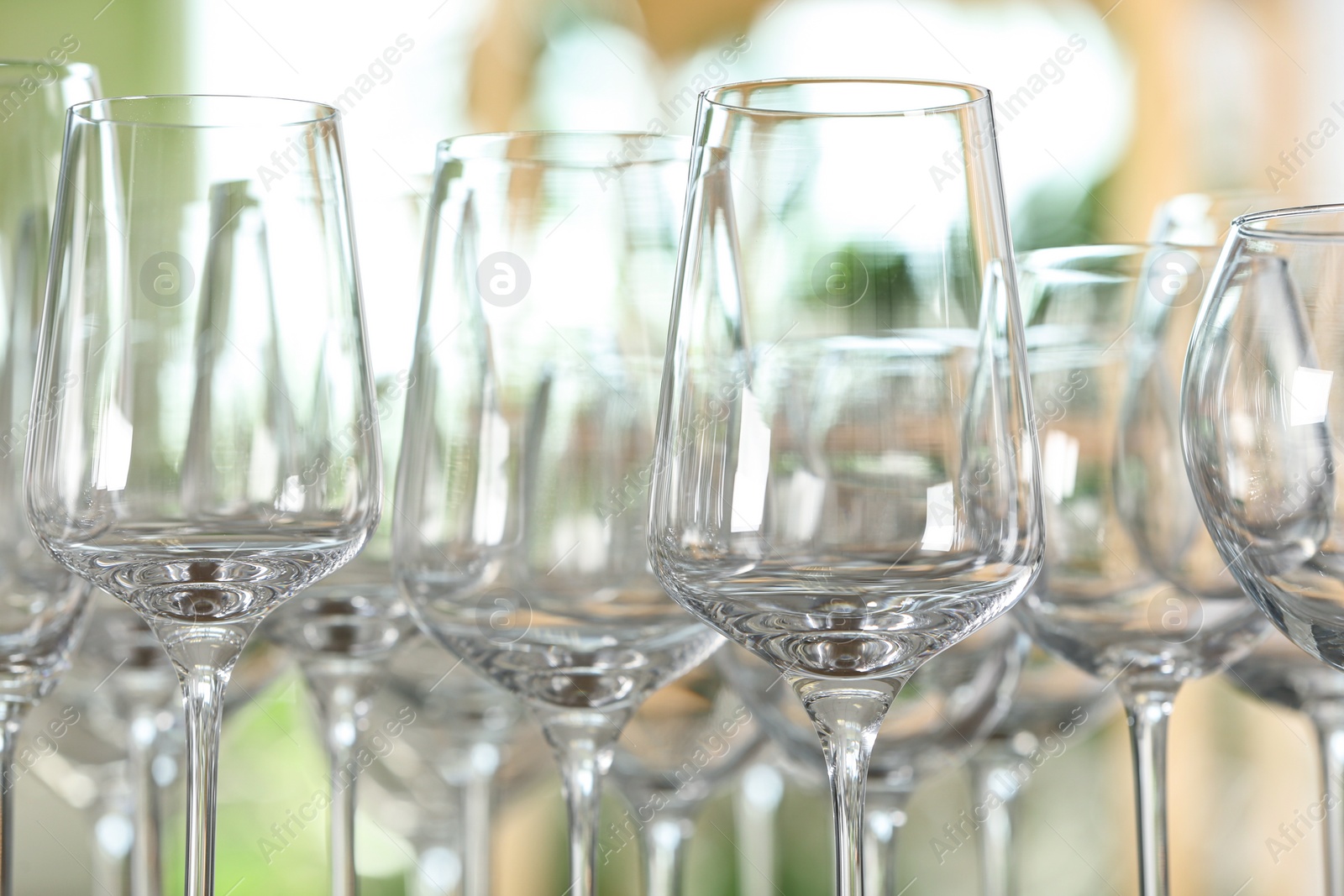 Photo of Empty glasses against blurred background, closeup view