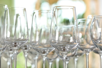 Photo of Empty glasses against blurred background, closeup view