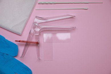 Photo of Sterile gynecological examination kit on pink background, flat lay. Space for text