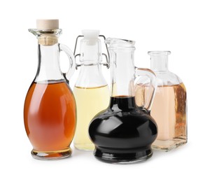 Photo of Different types of vinegar isolated on white