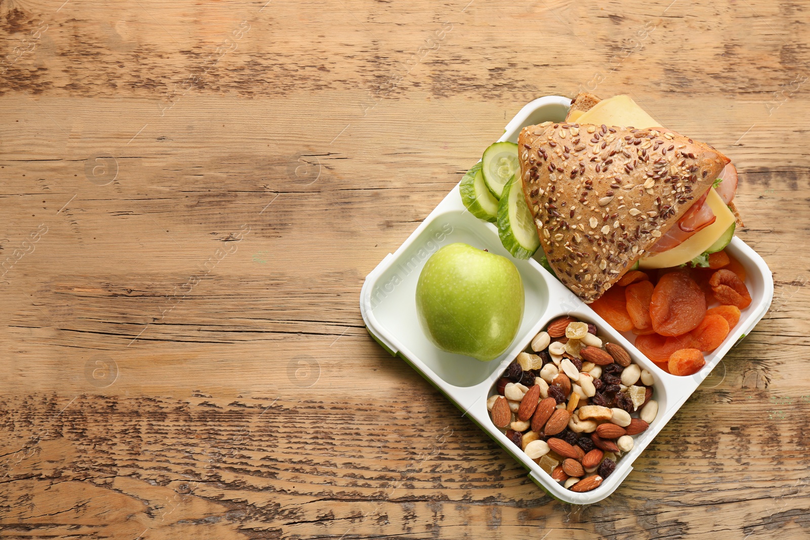 Photo of Lunch box with tasty food on wooden background