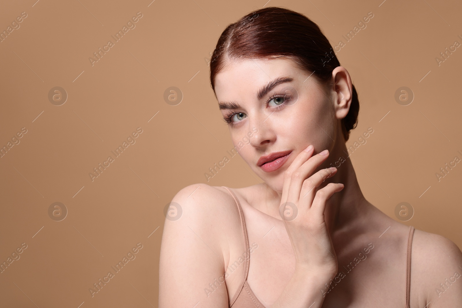 Photo of Portrait of beautiful woman on beige background. Space for text