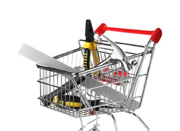 Photo of Small shopping cart with set of construction tools isolated on white
