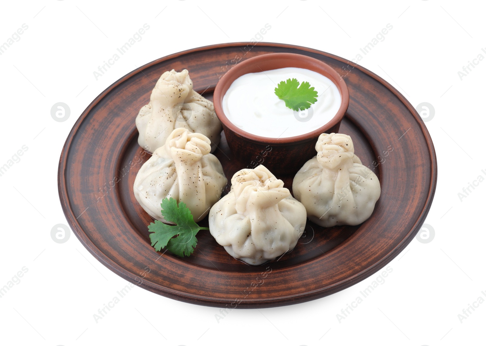 Photo of Tasty khinkali (dumplings) with sauce and spices isolated on white. Georgian cuisine