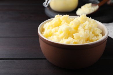 Photo of Bowl of Ghee butter on wooden table, closeup