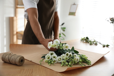 Florist making beautiful bouquet in workshop, closeup