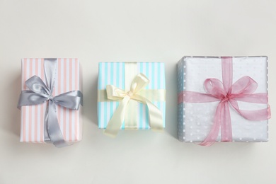 Photo of Beautifully decorated gift boxes on white background, top view