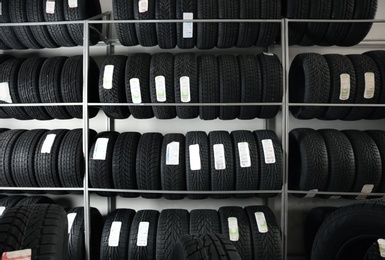 Photo of Car tires on racks in automobile service center