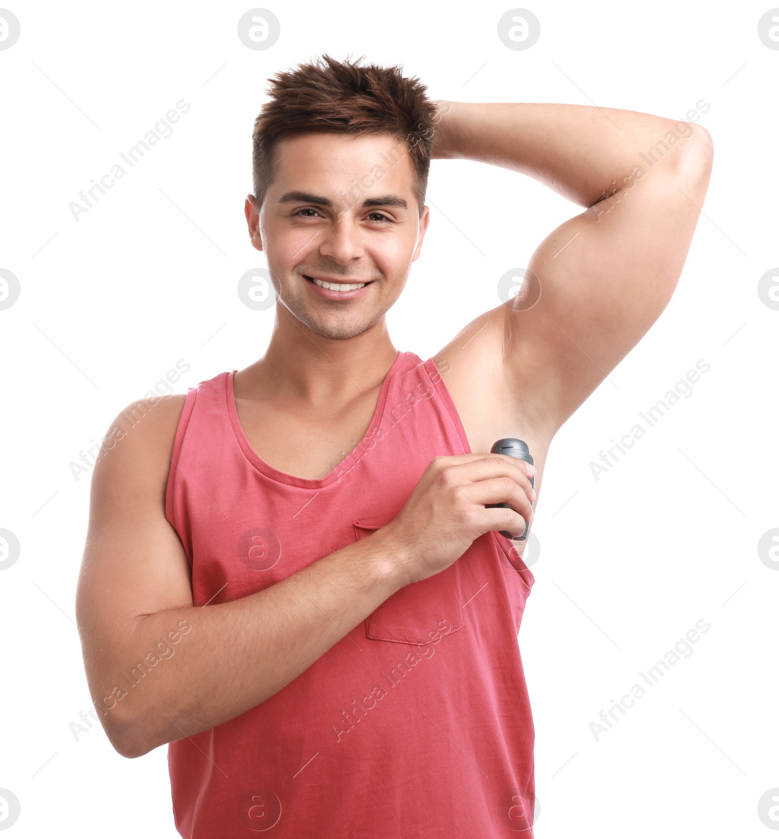 Photo of Young man applying deodorant to armpit on white background