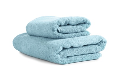 Folded clean soft towels on white background