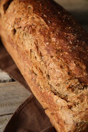 Freshly baked sourdough bread on wooden table, closeup