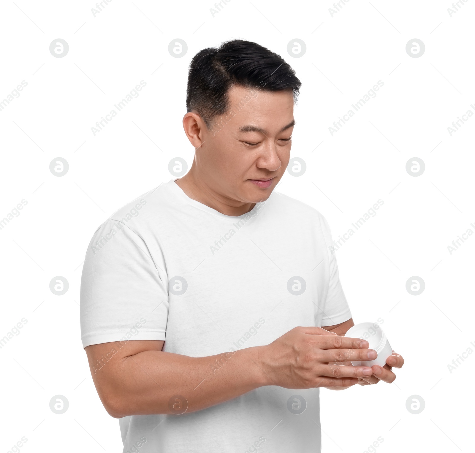 Photo of Handsome man with jar of body cream on white background