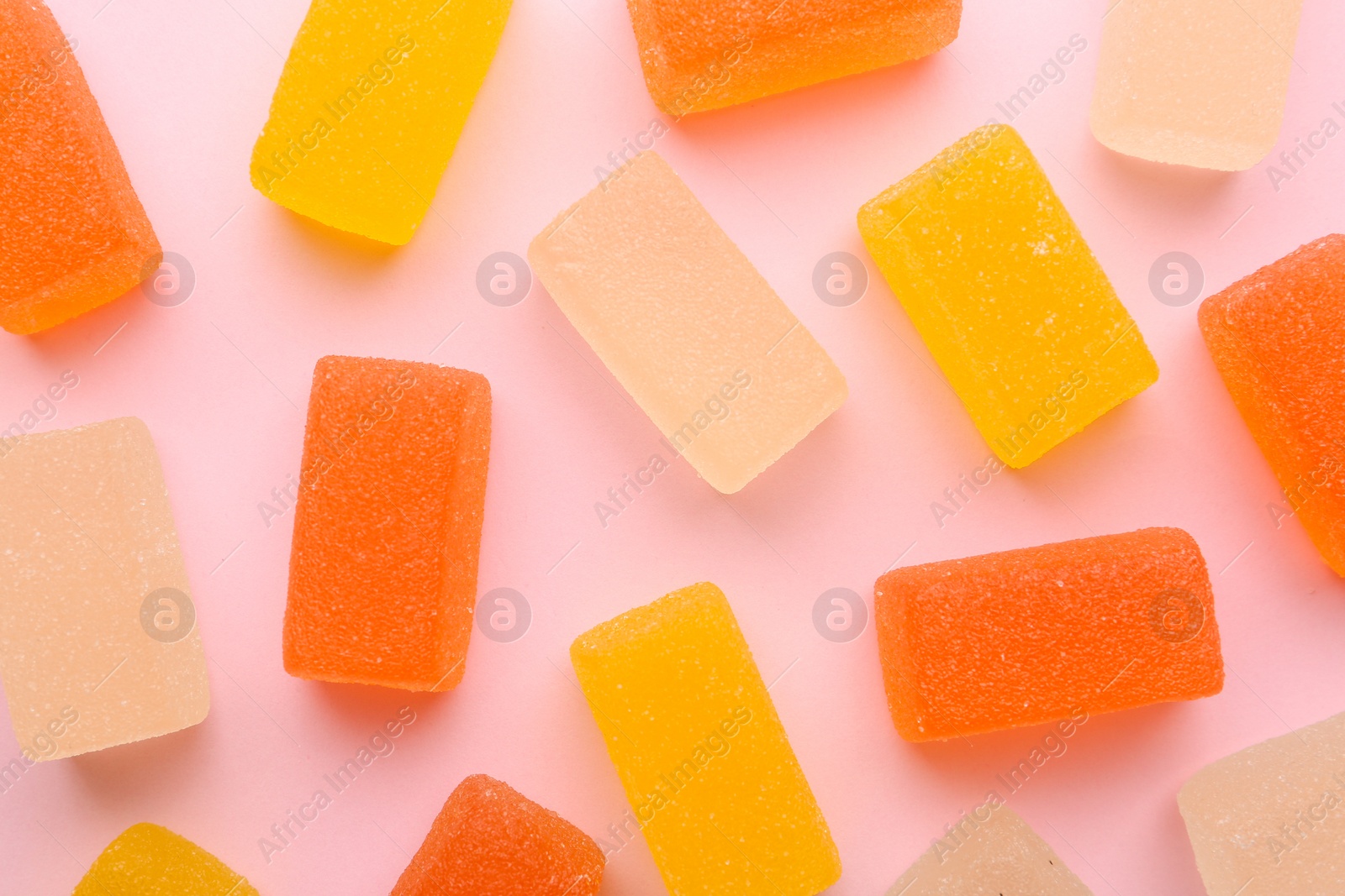 Photo of Tasty bright jelly candies on color background, top view