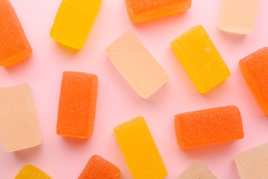 Tasty bright jelly candies on color background, top view