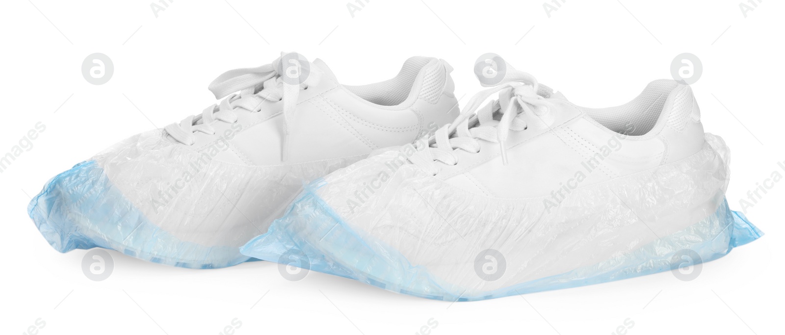 Photo of Sneakers in shoe covers isolated on white