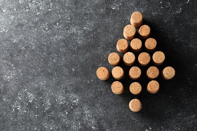Christmas tree made of wine corks on grey table, top view. Space for text